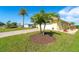 House exterior showcasing landscaping and a large palm tree at 49 Perimeter Dr, Englewood, FL 34223