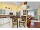 Kitchen boasts breakfast bar, stainless steel appliances, and yellow walls at 49 Perimeter Dr, Englewood, FL 34223