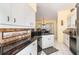 Spacious kitchen with granite countertops and stainless steel appliances at 49 Perimeter Dr, Englewood, FL 34223