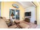 Relaxing lanai with wicker furniture and a large TV at 49 Perimeter Dr, Englewood, FL 34223