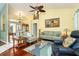 Comfortable living room with hardwood floors, featuring a couch and two armchairs at 49 Perimeter Dr, Englewood, FL 34223