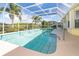 Relaxing pool area with screened enclosure and patio furniture at 49 Perimeter Dr, Englewood, FL 34223