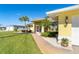 Sidewalk leads to house entrance with tropical landscaping at 49 Perimeter Dr, Englewood, FL 34223