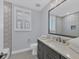 Modern bathroom with hexagonal tile, a large mirror, and dark vanity at 503 N Tamiami Trl # 301, Venice, FL 34285