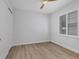 Bright and airy bedroom with wood-look flooring and window shutters at 503 N Tamiami Trl # 301, Venice, FL 34285
