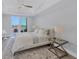 King bedroom with a ceiling fan and private balcony access at 503 N Tamiami Trl # 301, Venice, FL 34285
