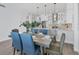 Elegant dining room with modern table and blue chairs at 503 N Tamiami Trl # 301, Venice, FL 34285