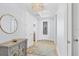 Bright and airy entryway with stylish console table and mirror at 503 N Tamiami Trl # 301, Venice, FL 34285