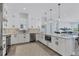 Modern kitchen with white cabinets, stainless steel appliances, and large island at 503 N Tamiami Trl # 301, Venice, FL 34285