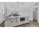 Modern kitchen with island, white cabinets, and stainless steel appliances at 503 N Tamiami Trl # 301, Venice, FL 34285