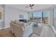 Bright living room with water views and sliding glass doors leading to balcony at 503 N Tamiami Trl # 301, Venice, FL 34285