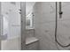Walk-in shower with marble tile and built-in seat at 503 N Tamiami Trl # 301, Venice, FL 34285