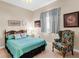 Bedroom with a double bed, chair, and window at 5031 Bella Terra Dr, Venice, FL 34293