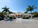 Community clubhouse with palm trees and ample parking at 5031 Bella Terra Dr, Venice, FL 34293