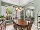 Bright dining room with large windows and elegant chandelier at 5031 Bella Terra Dr, Venice, FL 34293