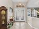 Elegant entryway with double doors and grand clock at 5031 Bella Terra Dr, Venice, FL 34293