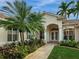 Inviting home exterior with a palm tree and walkway at 5031 Bella Terra Dr, Venice, FL 34293