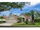 Beautiful home with two-car garage and lush landscaping at 5031 Bella Terra Dr, Venice, FL 34293