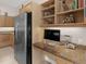 Well-equipped kitchen with granite countertops and built-in desk at 5031 Bella Terra Dr, Venice, FL 34293
