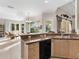Kitchen boasts granite countertops and breakfast bar at 5031 Bella Terra Dr, Venice, FL 34293