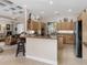 Island kitchen features granite countertops and breakfast bar at 5031 Bella Terra Dr, Venice, FL 34293