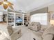 Spacious living room featuring comfortable seating and built-in shelving at 5031 Bella Terra Dr, Venice, FL 34293