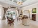 Comfortable living room with pool access and high ceiling at 5031 Bella Terra Dr, Venice, FL 34293