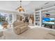 Bright living room with pool access and built-in shelving at 5031 Bella Terra Dr, Venice, FL 34293