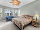 Spacious main bedroom with a king-size bed and sitting area at 5031 Bella Terra Dr, Venice, FL 34293