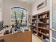 Home office with large window, desk, and bookcase at 5031 Bella Terra Dr, Venice, FL 34293