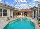 Inviting screened pool and spa, perfect for relaxation at 5031 Bella Terra Dr, Venice, FL 34293