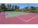 Well-maintained tennis court with surrounding greenery at 5031 Bella Terra Dr, Venice, FL 34293