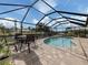 Enclosed pool and patio area with seating for entertaining at 505 S Shore Dr, Osprey, FL 34229