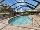 Relaxing screened-in pool with a large patio and canal views at 505 S Shore Dr, Osprey, FL 34229