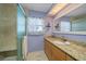 Bathroom with granite countertop, walk-in shower, and updated fixtures at 521 Roma Road, Venice, FL 34285