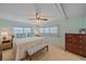 Main bedroom with a king-size bed, wooden dresser, and calming decor at 521 Roma Road, Venice, FL 34285