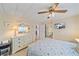 Bedroom with white dresser and patterned bedding, plus a view of the kitchen at 521 Roma Road, Venice, FL 34285