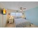 Bedroom with a queen bed, ceiling fan, and light colored walls at 521 Roma Road, Venice, FL 34285
