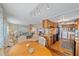 Open concept kitchen and dining area with granite countertops and wood cabinets at 521 Roma Road, Venice, FL 34285
