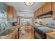 Modern kitchen featuring granite countertops, stainless steel appliances, and wood cabinets at 521 Roma Road, Venice, FL 34285