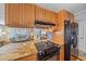 Updated kitchen with granite counters, stainless steel appliances, and wood cabinets at 521 Roma Road, Venice, FL 34285