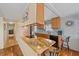 Eat-in kitchen with granite countertops, wood cabinets, and breakfast bar at 521 Roma Road, Venice, FL 34285