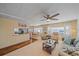 Living room with hardwood floors, comfortable seating, and kitchen view at 521 Roma Road, Venice, FL 34285