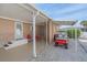 Covered patio with seating area and golf cart, adjacent to the house at 521 Roma Road, Venice, FL 34285
