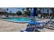 Community pool with lounge chairs and umbrellas at 521 Roma Road, Venice, FL 34285