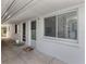 Condo exterior featuring a secure entrance, large window and covered walkway at 525 Manatee Ct # 4, Venice, FL 34285
