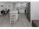 Bright, renovated kitchen featuring an island with a stool, stainless appliances, and eat-in dining space at 525 Manatee Ct # 4, Venice, FL 34285