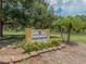 Sign to the Prentiss French Park with a yellow painted sign, bushes, mulch, and palm trees at 525 Manatee Ct # 4, Venice, FL 34285