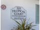 Close up of the 525 Tropical Court Condominium street sign with plants in front at 525 Manatee Ct # 4, Venice, FL 34285