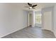 Bright bedroom with ceiling fan, wood-look floors, and ample closet space at 5541 Rosehill Rd # 201, Sarasota, FL 34233